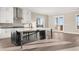 Open kitchen with stainless appliances, central island, access to porch and outdoor views at 231 Laurel Vista Dr, Canton, GA 30114