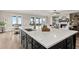 Kitchen island with a sink, contrasting cabinetry, and hardwood flooring in an open-concept design at 231 Laurel Vista Dr, Canton, GA 30114