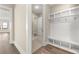 Mudroom with built-in storage and bench, located off hallway leading to laundry and other rooms at 231 Laurel Vista Dr, Canton, GA 30114