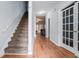 Inviting hallway with hardwood floors, staircase, and white trim, leading to other rooms in the home at 2735 Snapfinger Mnr, Decatur, GA 30035