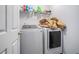 Functional laundry room with modern washer and dryer, plus convenient shelving at 2735 Snapfinger Mnr, Decatur, GA 30035