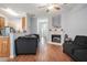 Bright living area featuring wood flooring, gray sofas, fireplace, and a view into the kitchen, perfect for modern living at 2735 Snapfinger Mnr, Decatur, GA 30035