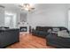 Spacious living room featuring a cozy fireplace, hardwood floors, neutral walls, and comfortable gray sofas at 2735 Snapfinger Mnr, Decatur, GA 30035
