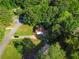 An aerial view shows the property nestled among mature trees, highlighting its serene location and surrounding neighborhood at 2849 Knotty Pine Ct, Buford, GA 30519