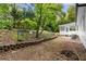 Backyard featuring a small patio and a mix of lawn and natural wooded areas at 2849 Knotty Pine Ct, Buford, GA 30519