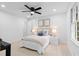 Bright bedroom with a modern fan, natural lighting, and carpeted floor at 2849 Knotty Pine Ct, Buford, GA 30519