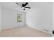 Well-lit bedroom features a ceiling fan, a window view, and neutral colors at 2849 Knotty Pine Ct, Buford, GA 30519