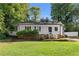 Well-maintained home featuring a charming front porch and landscaped lawn at 2849 Knotty Pine Ct, Buford, GA 30519