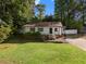 Charming single-story home with a welcoming front porch, a stone foundation, and a neatly landscaped front yard at 2849 Knotty Pine Ct, Buford, GA 30519