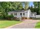 Charming, single-story home featuring a welcoming front porch, stone accents, and a well-maintained yard and long driveway at 2849 Knotty Pine Ct, Buford, GA 30519