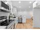 Well-lit kitchen boasts stainless appliances, white cabinetry, and an open layout at 2849 Knotty Pine Ct, Buford, GA 30519