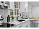 Kitchen featuring stainless appliances, white cabinets, granite countertops and modern fixtures at 2849 Knotty Pine Ct, Buford, GA 30519