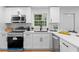 Bright kitchen features white cabinets, stainless appliances, and a modern design at 2849 Knotty Pine Ct, Buford, GA 30519
