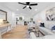 Open-concept living area boasts lots of light, modern decor, and a smooth transition to the dining area at 2849 Knotty Pine Ct, Buford, GA 30519