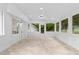 Sunroom featuring tile floors, white walls, and multiple windows that overlook the surrounding greenery at 2849 Knotty Pine Ct, Buford, GA 30519