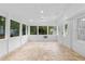 All-white sunroom with multiple windows offering natural light and a tiled floor for easy maintenance at 2849 Knotty Pine Ct, Buford, GA 30519