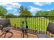 Brick balcony with chairs and small table overlooks a green space with rows of grave markers at 351 Ne Washington Ne Ave # 307, Marietta, GA 30060