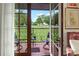 Balcony view shows green grass, rows of grave markers, trees, and patio furniture at 351 Ne Washington Ne Ave # 307, Marietta, GA 30060