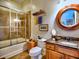 Bathroom featuring a tub/shower combo, decorative mirror and vanity with dark countertop at 351 Ne Washington Ne Ave # 307, Marietta, GA 30060