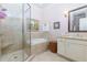 Elegant bathroom featuring a glass-enclosed shower, soaking tub, and classic vanity at 351 Ne Washington Ne Ave # 307, Marietta, GA 30060