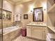 Bright bathroom with a soaking tub, white cabinets, and marble countertops at 351 Ne Washington Ne Ave # 307, Marietta, GA 30060
