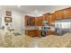 Kitchen featuring wooden cabinets, granite countertops, stainless steel appliances, and a white subway tile backsplash at 351 Ne Washington Ne Ave # 307, Marietta, GA 30060