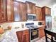 This kitchen features wood cabinets, stainless steel appliances, granite countertops, and tile backsplash at 351 Ne Washington Ne Ave # 307, Marietta, GA 30060