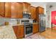 Charming kitchen features wood cabinets, granite countertops, and stainless steel appliances at 351 Ne Washington Ne Ave # 307, Marietta, GA 30060