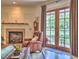 Cozy living room showing fireplace, bookshelves and French doors leading to a balcony at 351 Ne Washington Ne Ave # 307, Marietta, GA 30060
