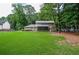 Large, well-maintained backyard featuring a lush lawn and a charming two-story home at 1206 Tred Avon Sw Way, Lilburn, GA 30047