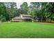 Expansive, well-manicured backyard with a screened porch, offering a serene outdoor living space at 1206 Tred Avon Sw Way, Lilburn, GA 30047