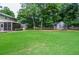 Lush backyard with mature trees, offering a private and serene outdoor space for relaxation and play at 1206 Tred Avon Sw Way, Lilburn, GA 30047