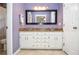Stylish bathroom with a double vanity, granite countertop, and a well-lit mirror, offering a modern design at 1206 Tred Avon Sw Way, Lilburn, GA 30047