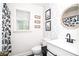 Charming bathroom featuring playful wallpaper, modern fixtures, and an inviting shower curtain with cute woodland creatures at 1206 Tred Avon Sw Way, Lilburn, GA 30047