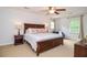 Spacious primary bedroom with a king-size bed, ceiling fan, natural light, and comfortable furniture at 1206 Tred Avon Sw Way, Lilburn, GA 30047
