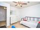 Bright bedroom with a ceiling fan, white dresser, and a cozy bed, perfect for relaxation at 1206 Tred Avon Sw Way, Lilburn, GA 30047