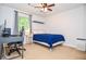 Bedroom with dark ceiling fan and a bed with blue comforter, desk and computer at 1206 Tred Avon Sw Way, Lilburn, GA 30047