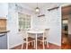 Cozy breakfast nook with white wainscoting, wallpaper, and a charming round table at 1206 Tred Avon Sw Way, Lilburn, GA 30047