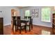 Cozy dining room featuring warm hardwood floors and serene view to exterior at 1206 Tred Avon Sw Way, Lilburn, GA 30047