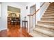 Welcoming entryway with hardwood floors, carpeted stairs, and a view into the dining room at 1206 Tred Avon Sw Way, Lilburn, GA 30047