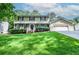 Charming two-story home with manicured lawn, attached garage, and classic architectural details at 1206 Tred Avon Sw Way, Lilburn, GA 30047