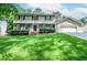 Inviting home featuring a lush front lawn, attached garage and traditional architectural elements at 1206 Tred Avon Sw Way, Lilburn, GA 30047