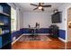 Inviting home office featuring built-in shelves, neutral walls, hardwood floors, and modern ceiling fan at 1206 Tred Avon Sw Way, Lilburn, GA 30047