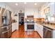 Well-lit kitchen with stainless steel appliances, white cabinets, and granite countertops at 1206 Tred Avon Sw Way, Lilburn, GA 30047
