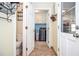 Bright laundry room with a modern washer and dryer, white cabinets, and a view of the bathroom and exterior at 1206 Tred Avon Sw Way, Lilburn, GA 30047