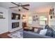 Charming living room showcasing hardwood floors, a brick fireplace, and a comfortable gray sectional at 1206 Tred Avon Sw Way, Lilburn, GA 30047