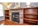 Cozy fireplace nestled between custom wood bookshelves, complemented by pristine hardwood floors at 1206 Tred Avon Sw Way, Lilburn, GA 30047