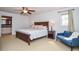 Large bedroom with a king bed, seating area, and view of the ensuite bathroom with granite countertops at 1206 Tred Avon Sw Way, Lilburn, GA 30047