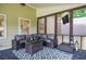 Stylish screened porch featuring comfortable seating and a mounted TV for outdoor entertainment at 1206 Tred Avon Sw Way, Lilburn, GA 30047