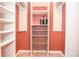 Spacious walk-in closet with custom shelving, drawers, and racks for optimal storage and organization at 1206 Tred Avon Sw Way, Lilburn, GA 30047